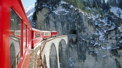 HD Wallpaper Red Train in Natures Winter Wonderland with Mountains and Snow