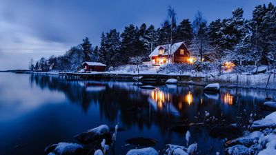 Golden Hour Bliss HD Wallpaper of a Lighted House Near Calm Body of Water during Sunset