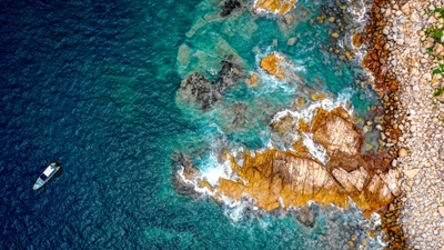 Serene Rocky Beach Scene with Boat Coastal Bliss Capture