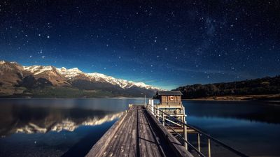 4K HD Wallpaper Black and Brown Wooden Docks under Starry Night with Stars  Tranquil Scene of Reflection Mountains and Nature